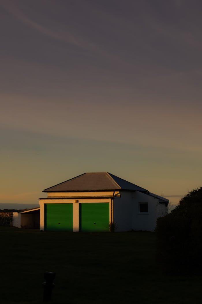 The Art of Drawing Readers In: Your attractive post title goes here A serene twilight scene of a house with distinct green doors in Broadstairs, UK.
